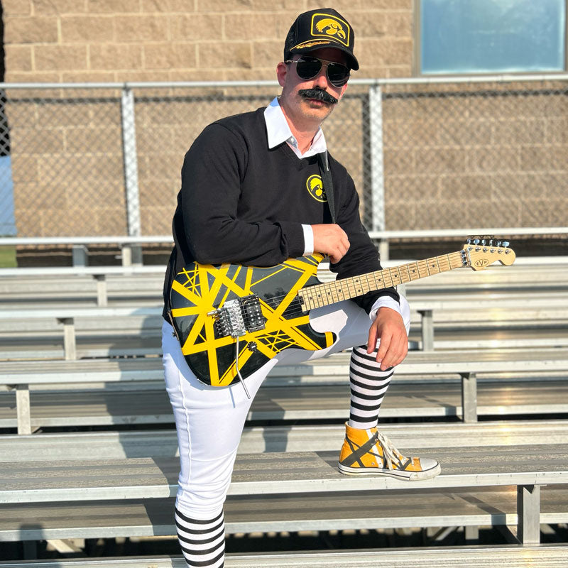Eddie Van Hayden with bumblebee style guitar on the bleachers