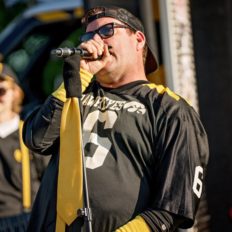 Sammy Frygar in an Iowa Hawkeye jersey with number 6 singing into a microphone.